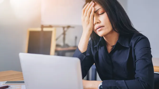 Woman frustrated with hand to her forehead.