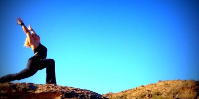 Woman doing yoga on rock
