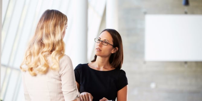 Two women talking in office