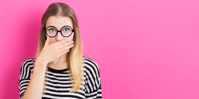 Woman covering her mouth