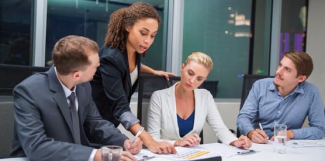woman speaking to employees