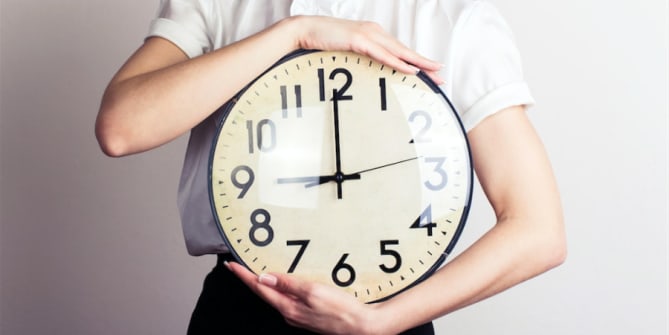 Woman holding clock