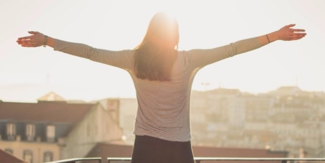 Woman standing arms outstretched