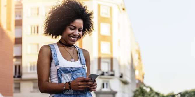 Woman laughing at phone