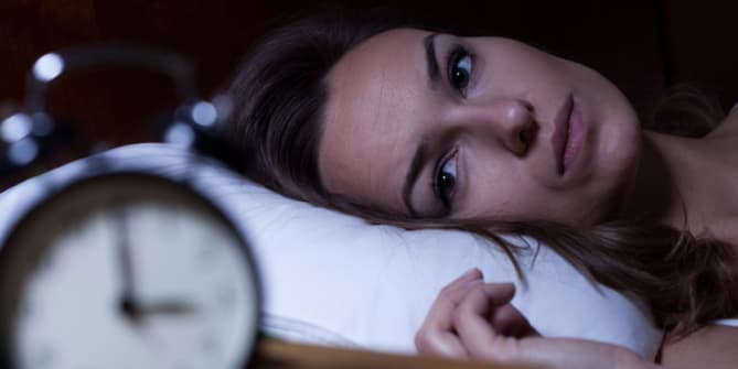 Woman lying awake in bed