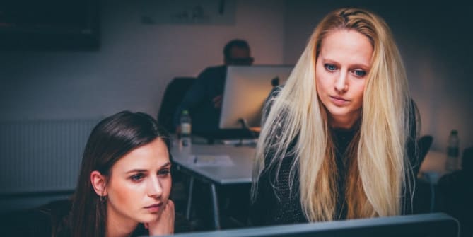 Mentor and mentee at a computer