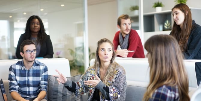 woman delivering feedback to a team at work