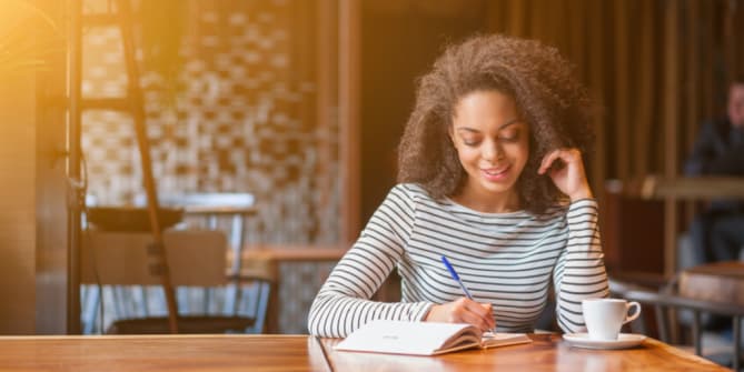 woman writing in wedding journal