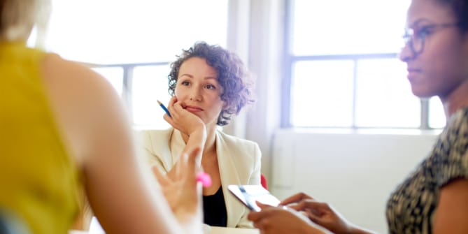woman at work talking to another person