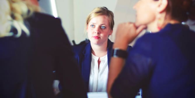 Woman talking to managers