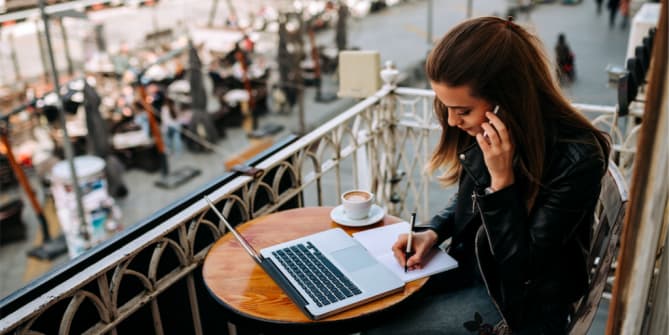 Woman Working on Computer at Beach