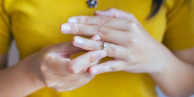Woman taking off wedding ring