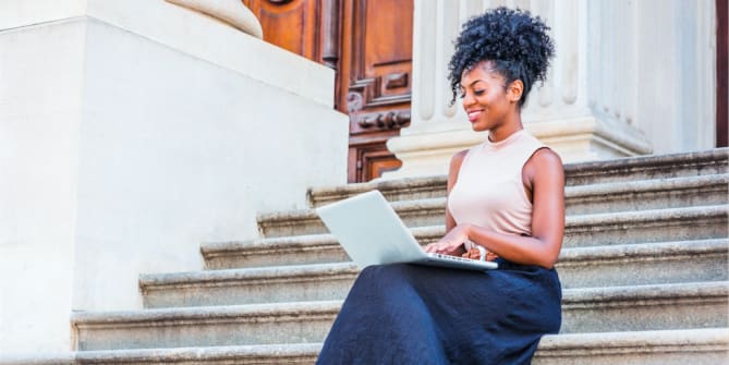 A woman sitting in front of a building