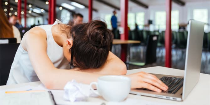woman sleeping at desk