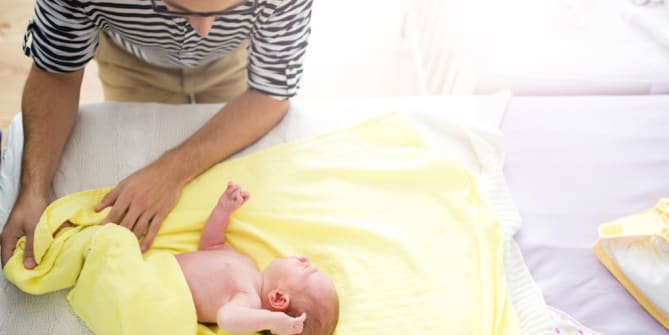 Dad Changing Baby Daughter
