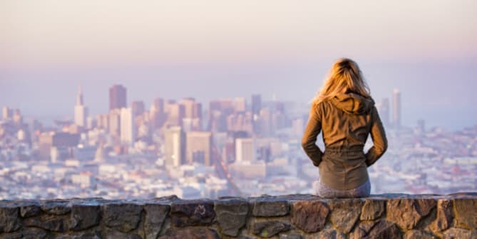 Woman sitting on wall