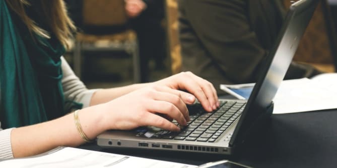 woman typing on laptop