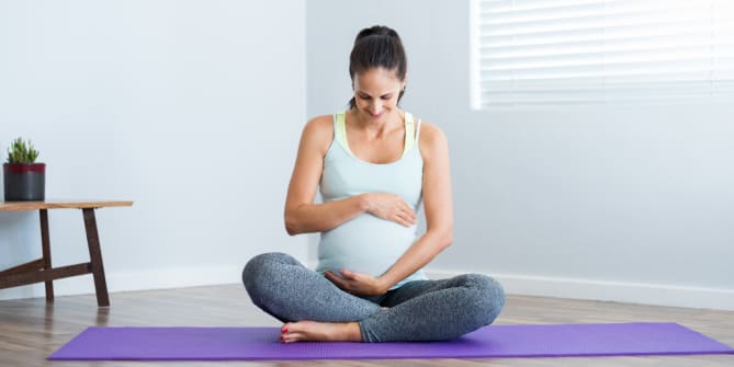 pregnant woman on a yoga mat