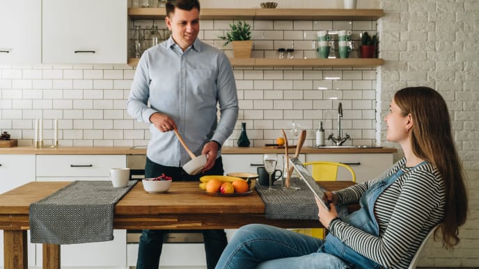 Pregnant woman and man in kitchen