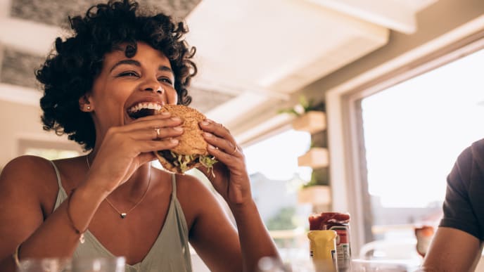happy woman eating burger