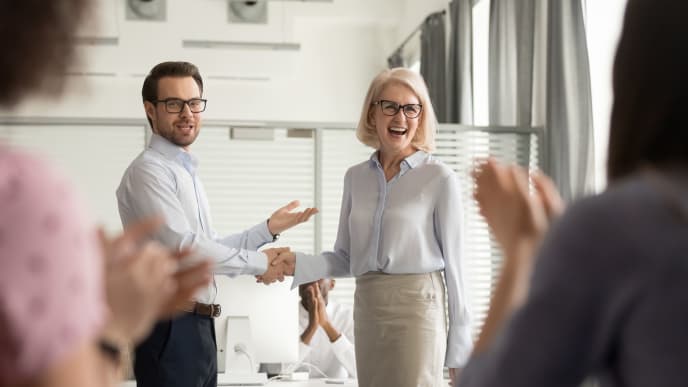 Woman shaking hands with colleague