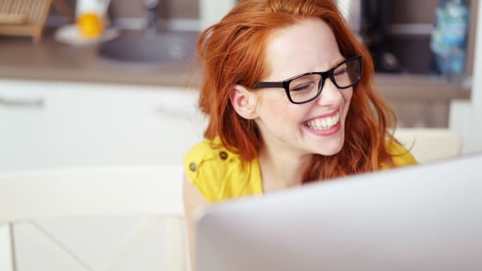 Woman Laughing at Computer