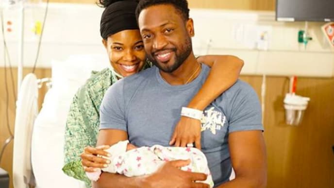 Gabrielle Union and Dwayne Wade holding their newborn