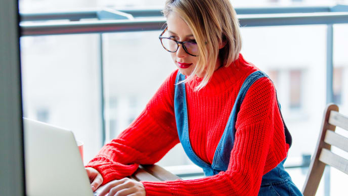 Woman in sweater on laptop