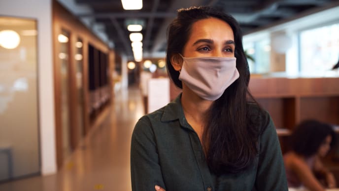 woman in office with mask on