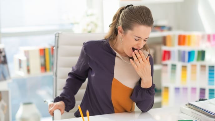 woman yawning at work
