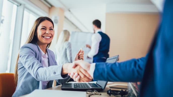 woman shaking hand at business meeting