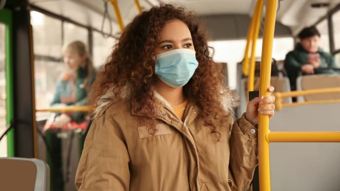 Woman on bus with mask on
