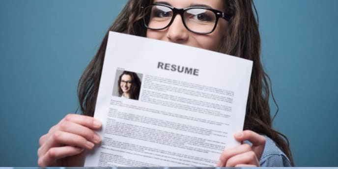 Woman hiding behind resume