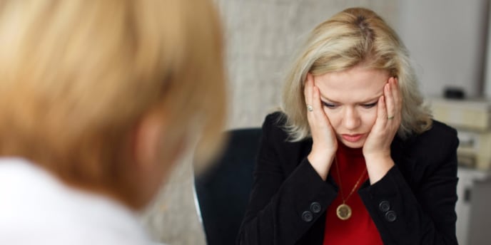 Stressed out woman at meeting