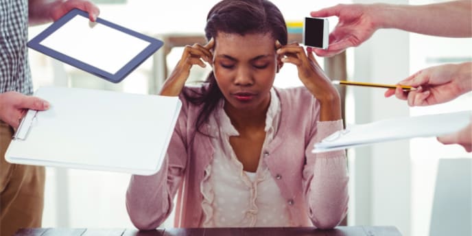 stressed out woman sitting at her desk