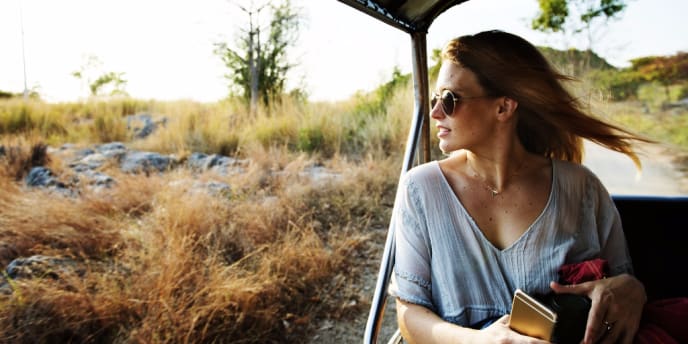 Woman with sunglasses in safari vehicle