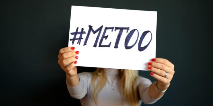 woman holding a #MeToo sign