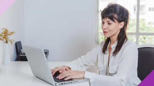 A woman typing in a laptop to illustrate the importance of learning how to bulletproof your resume and linkedIn against hiring bias