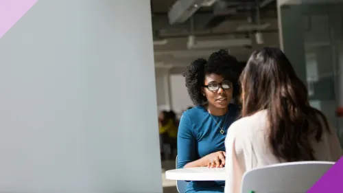 Two women in an office having a job interview to illustrate the importance of learning what do when you're feeling nervous in job interviews.