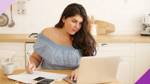 Woman at a table planning their finances