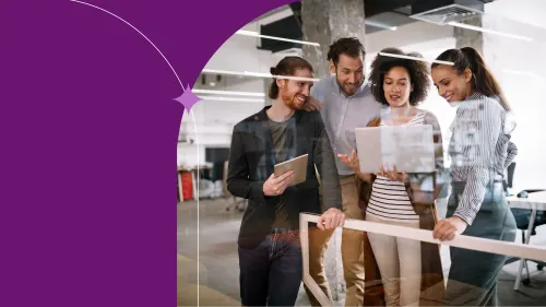 Coworkers collaborating during a team meeting with on a notebook