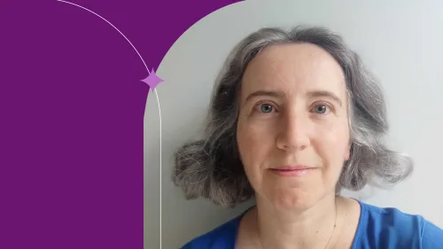 woman smiling front, grey hair, blue shirt