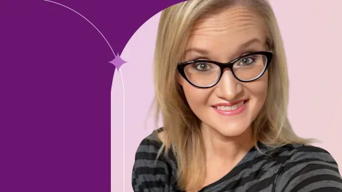 Tosh is in front of a pink background, wearing glasses and a black stripes t-shirt, smiling.