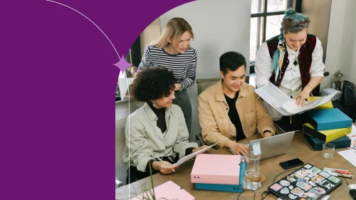 Diverse coworkers collaborating on laptops in a modern tech office, reflecting industries like finance and engineering.