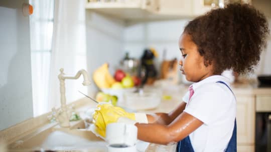 young girl washing dishes