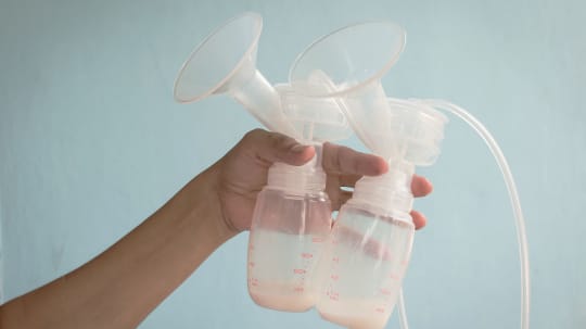 woman holding breast pump