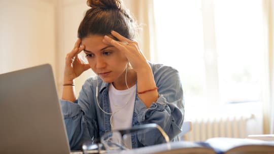 Woman on laptop stressed