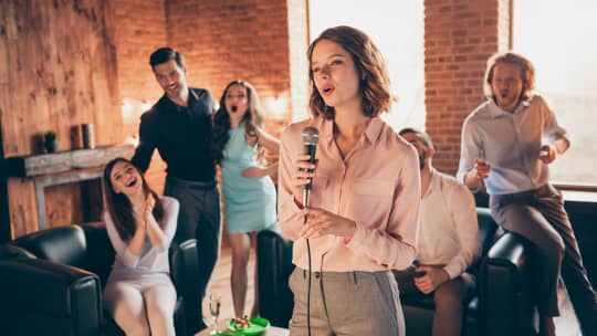 women singing karaoke