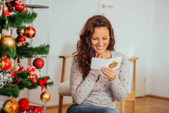 Woman Reading Holiday Card