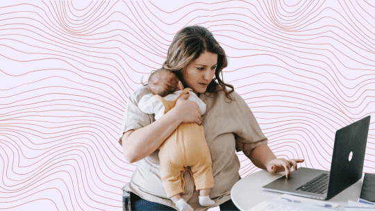 woman on laptop holding baby